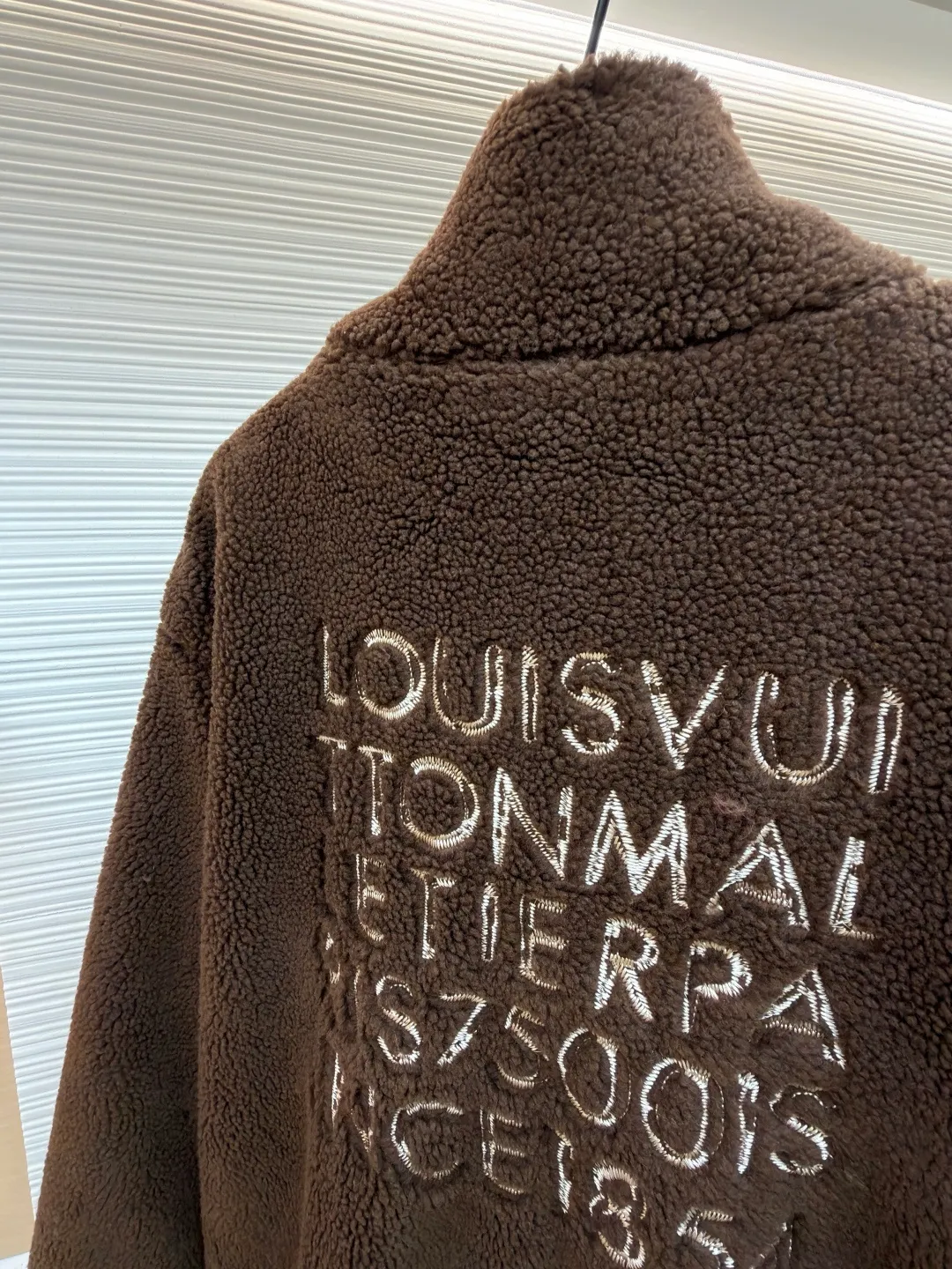 LOUIS VUITTON solid color zipper suede waist long-sleeved velvet jacket ●Original version: Purchased and developed for 17000 ●Item number: 1682255-B50 ●Fabric: cotton fabric ●Technology: Made on positioning cutting machine ●Color: brown ●Version: fitted version ●Weight: about 975 grams ●Size: S-M-L-XL ●Description: This brown lambswool jacket with LVM logo is made of imported imitation lambswool fabric, which has been processed by double carding and shearing processes. The pile length is even to 12mm. It feels fluffy and soft and is not prone to lint and pilling. The bottom layer of the fabric is compounded with waterproof polyester lining, which is seamlessly bonded through a heat-pressing lamination process, effectively locking in temperature and preventing linting. The body adopts a loose shoulder-drop design, and the three-dimensional tailoring technology allows the shoulders and body to connect naturally without any stiff splicing. The front is equipped with a customized brass zipper, which has been treated with electroplating and anti-oxidation, making it smooth and durable. The LVM logo on the left chest is made of three-dimensional embroidery technology, using high-twist cotton thread and flat embroidery stitching. The stitching is dense and does not skip stitches. The ribbed edges on the neckline and hem are made of spandex blended material, which has been pre-shrunk and has long-lasting elasticity without sagging. The overall seams use dual hemming and overlocking techniques, with 11 stitches per inch, taking into account the firmness of the fit and durability. The overall wiring is straight and delicate, the fabric is comfortable and soft, and the color is consistent without color difference. It can be matched with the same style to create a fashionable look and control various occasions. Customized accessories, complete with three standards, same style for men and women!